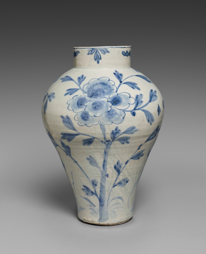 Underglaze-blue peony and bird marks vary in density across a curved white porcelain vase with glossy highlights.