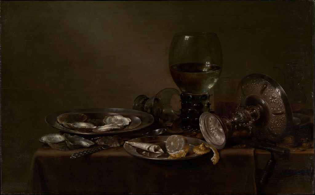 Heda's still life arranges oysters glass vessels silver dishes a peeled lemon and cloth across a dark table.
