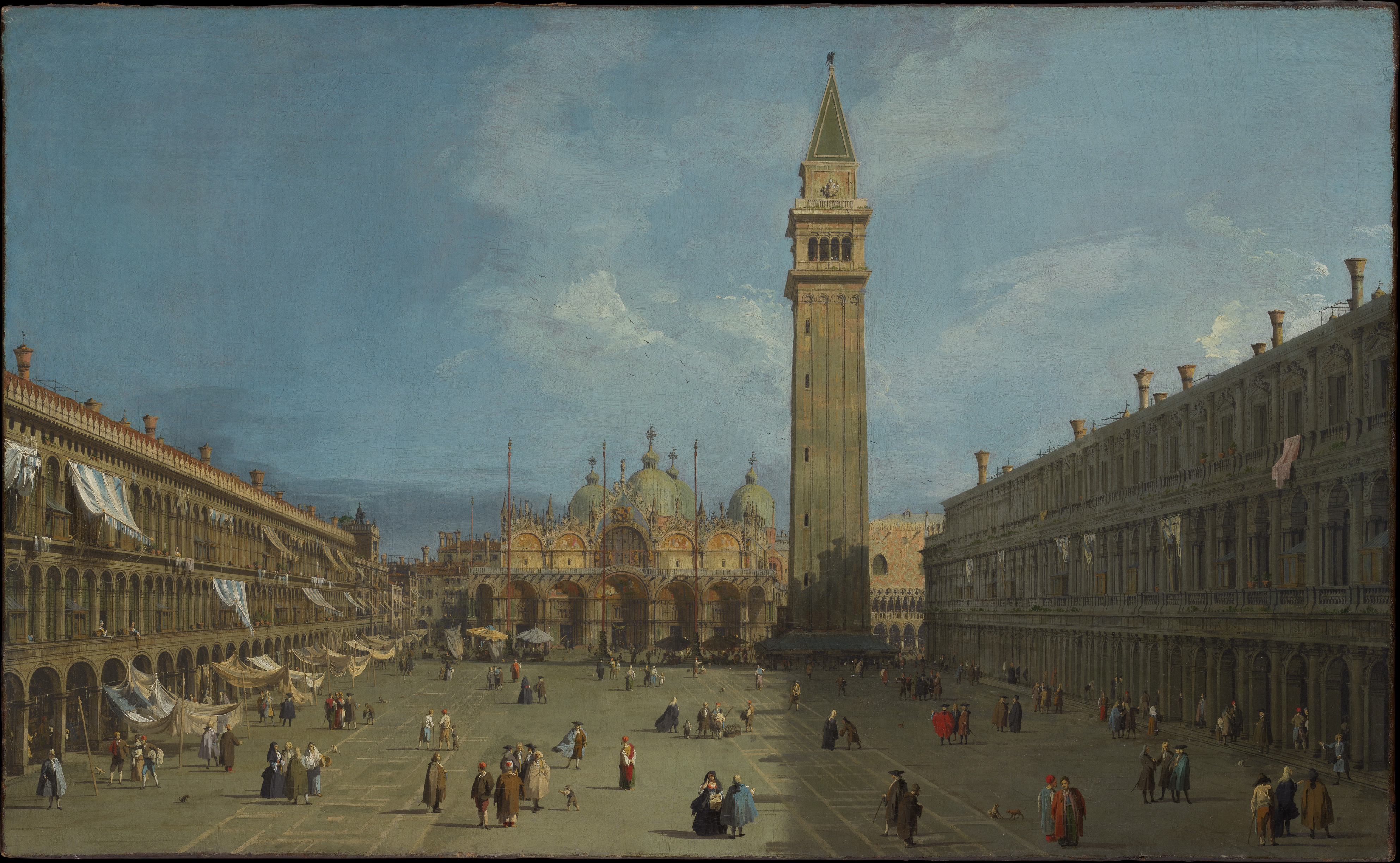 A broad Venetian square narrows between long arcaded buildings toward the basilica and bell tower under a bright sky.