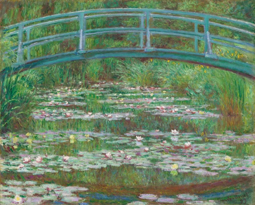 Monet's Japanese Footbridge arches in blue-green over a pond filled with green reflections and scattered pale water lilies.