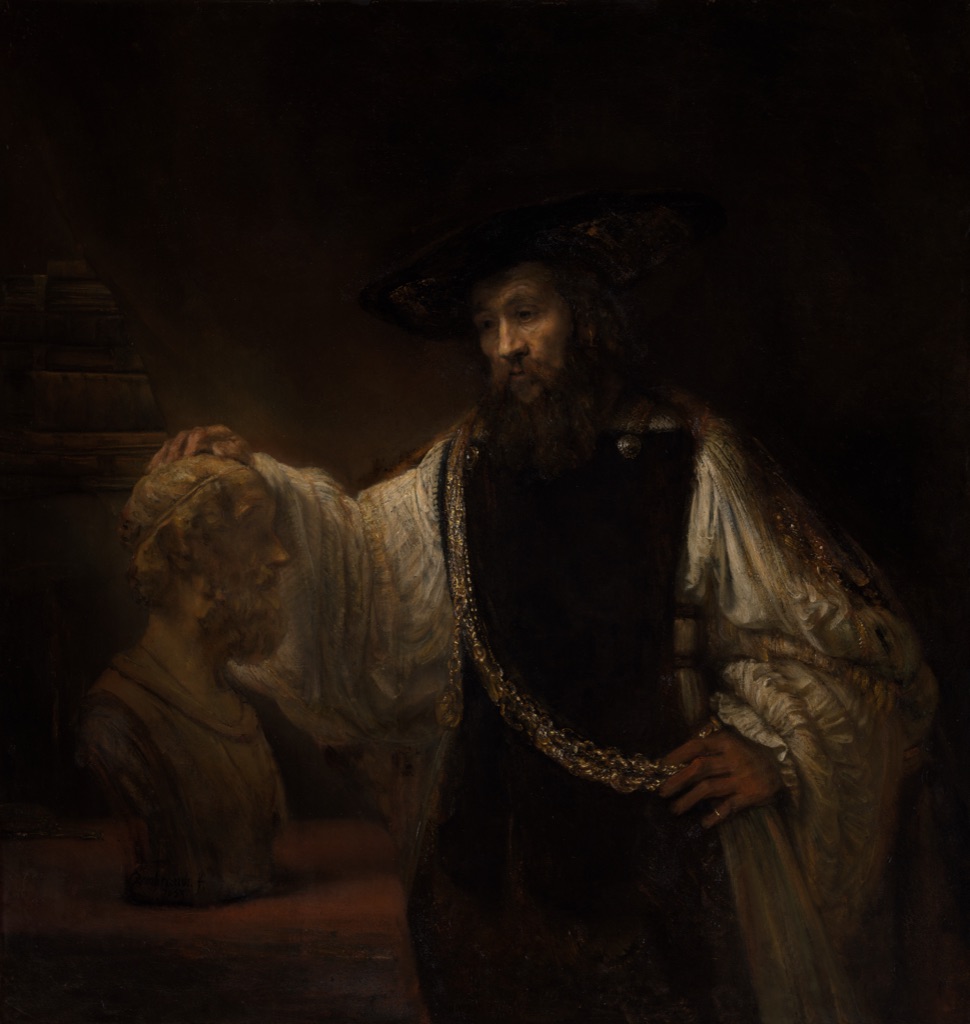 Rembrandt's Aristotle rests one hand on a pale bust of Homer while light catches his face, hands, sleeve and gold chain.