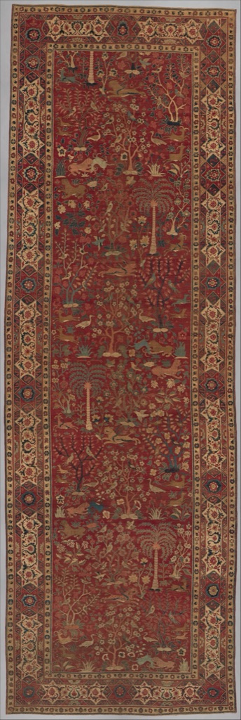 A long red carpet repeats palm trees, birds and paired animals in changing directions within a patterned border.