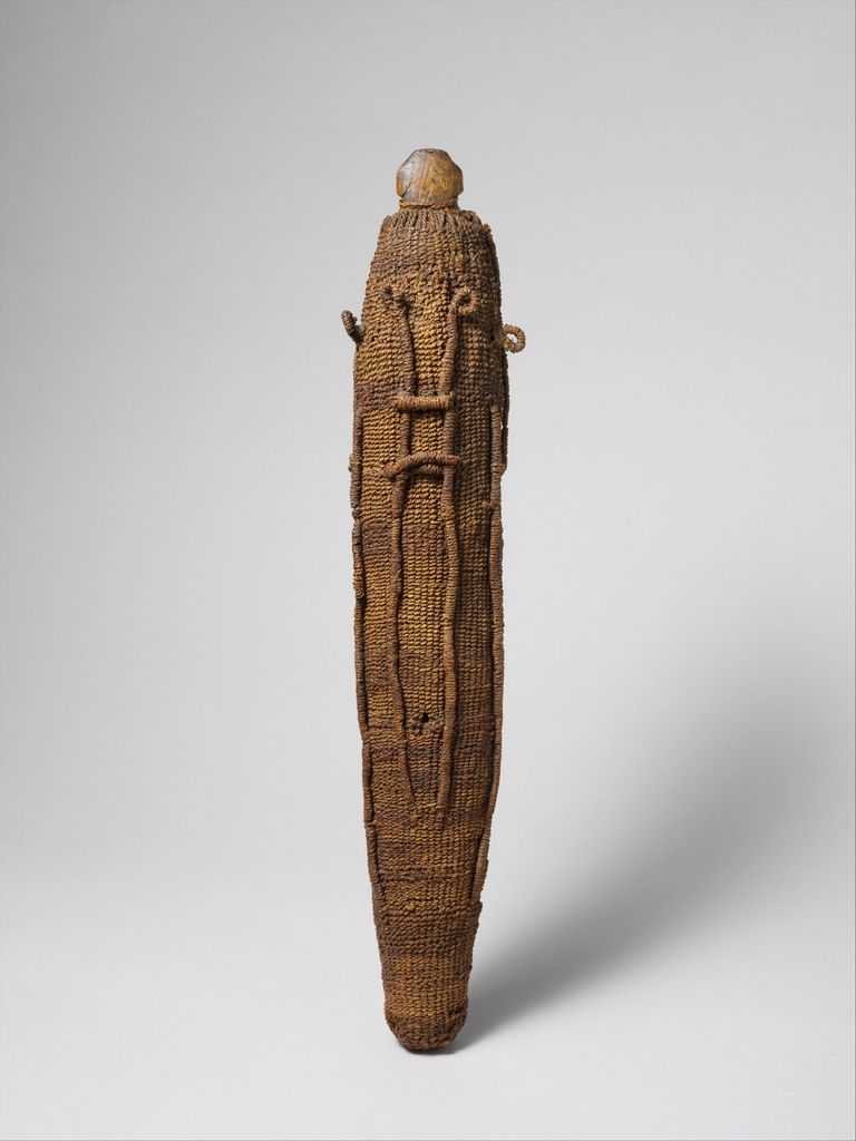 A tall narrow Mā'ohi ritual image is wrapped in coconut fibre cord, with small loops and projections marking features on the complete object.
