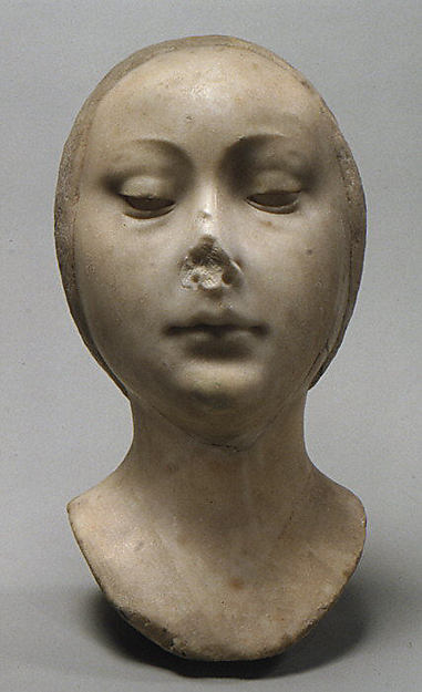 Small marble head or mask of a young woman with smooth oval features and downcast eyes.