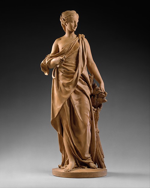 Buff terracotta model of Ceres standing in drapery with a reddish patinated surface.