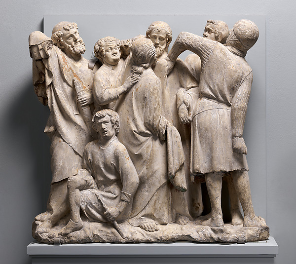 Medieval limestone relief with tightly packed figures in the Betrayal and Arrest of Jesus.