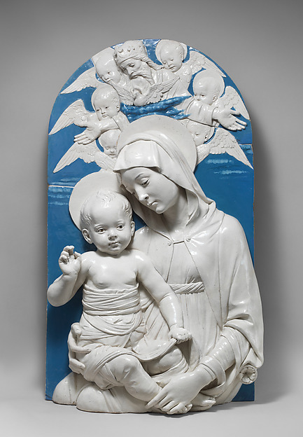 Glazed terracotta relief of the Madonna and Child in white and blue within a circular frame.