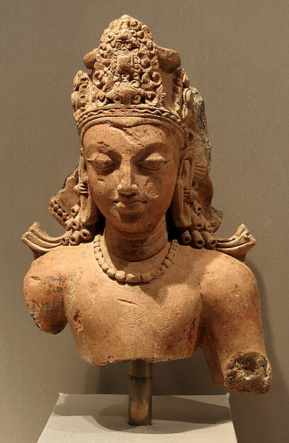 Terracotta bust of Vishnu with a high crown and crisply defined jewellery.
