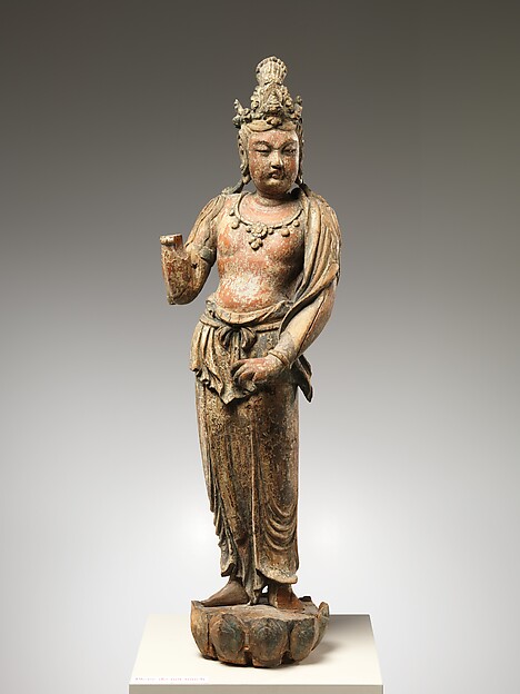 Seated Chinese Guanyin carved from willow with traces of pigment.